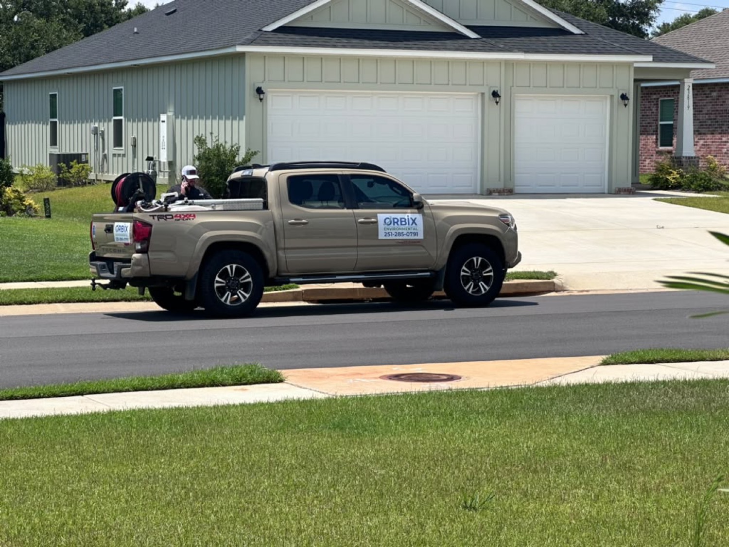 Orbix Environmental service truck on a residential street